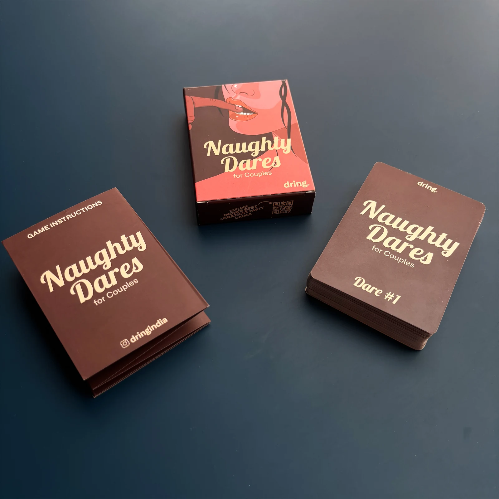Naughty Dares packaging, instruction booklet, and card deck on a dark surface