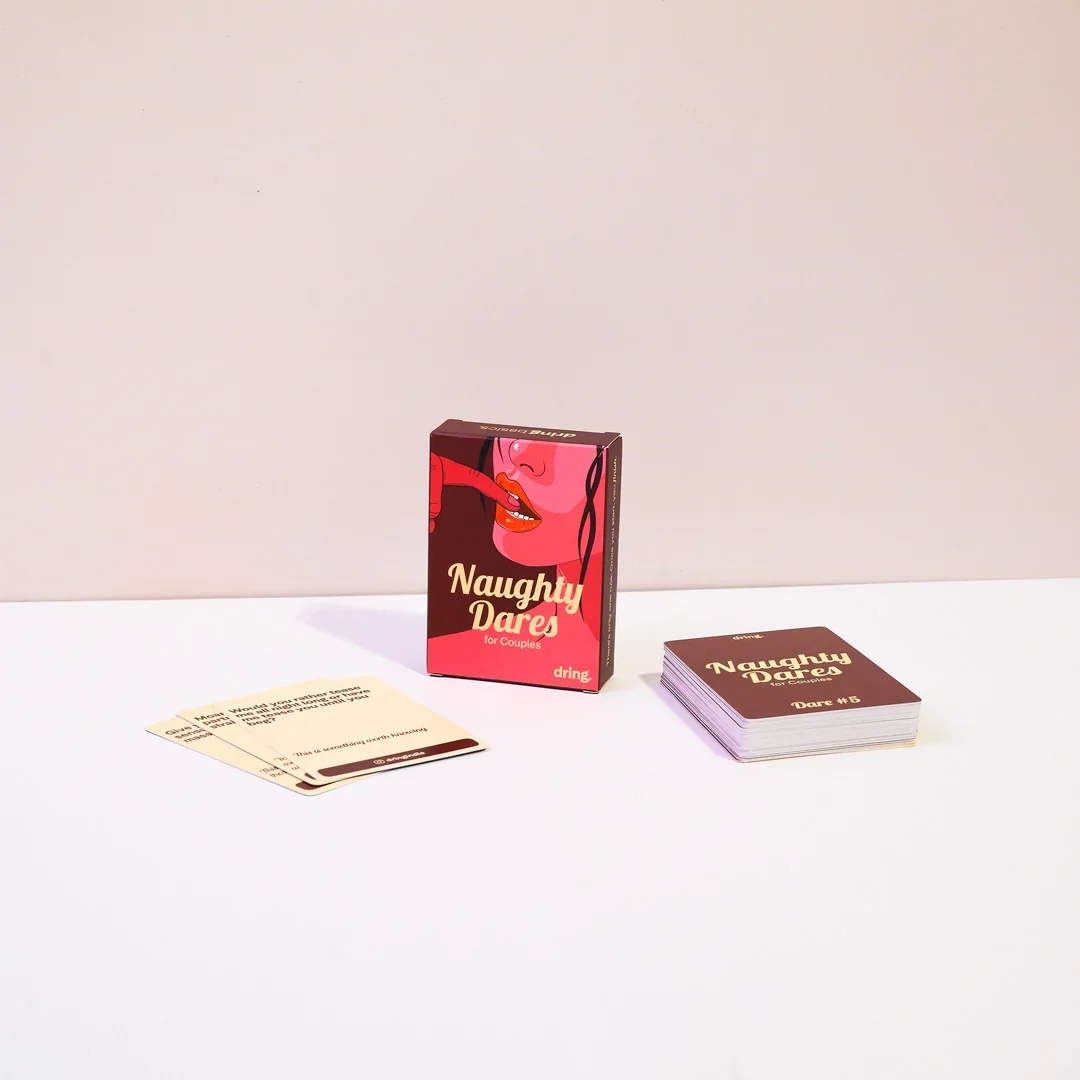 Naughty Dares box with card fan on a light background