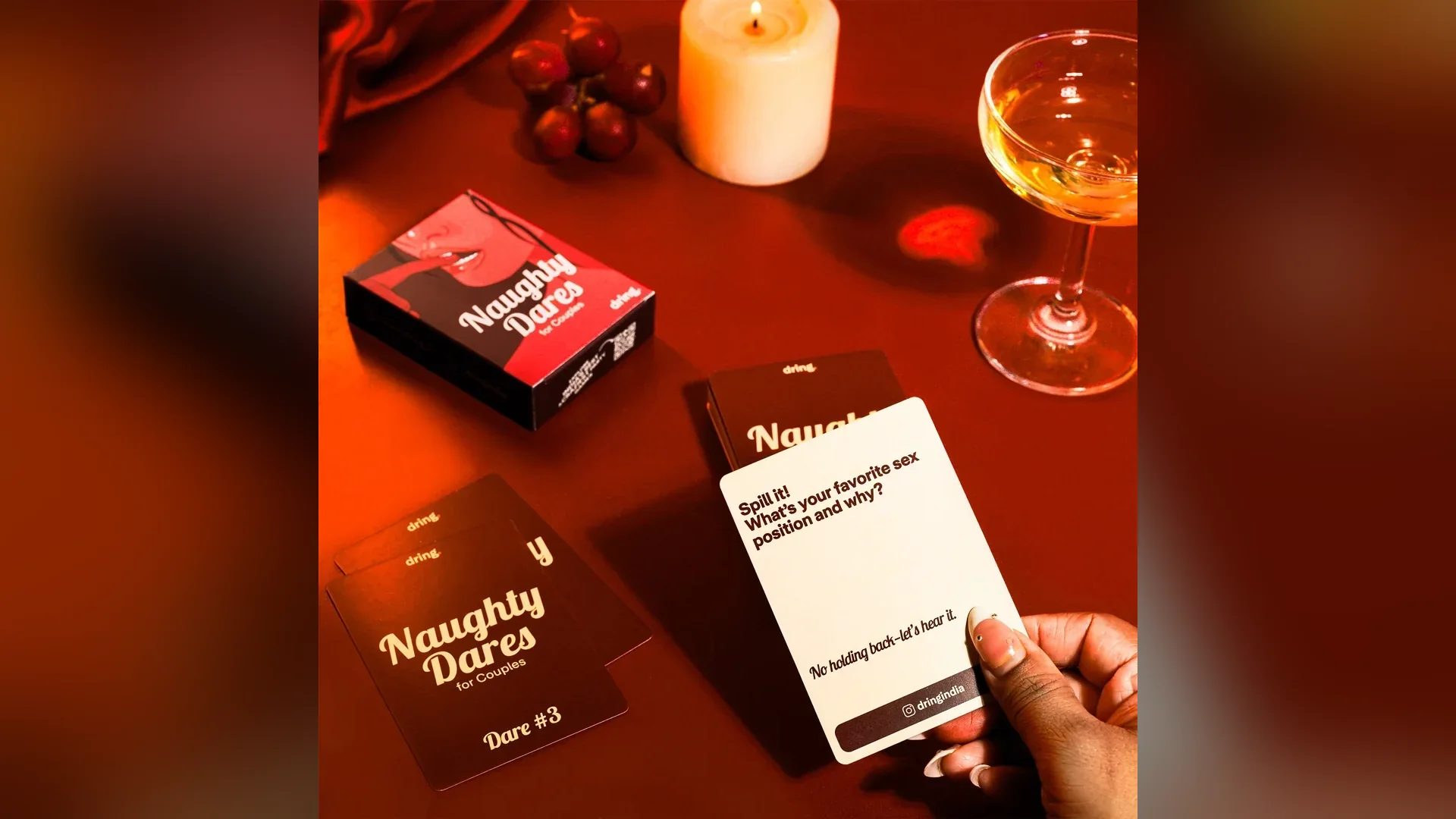 Naughty Dares — a card being read at a candlelit table with wine